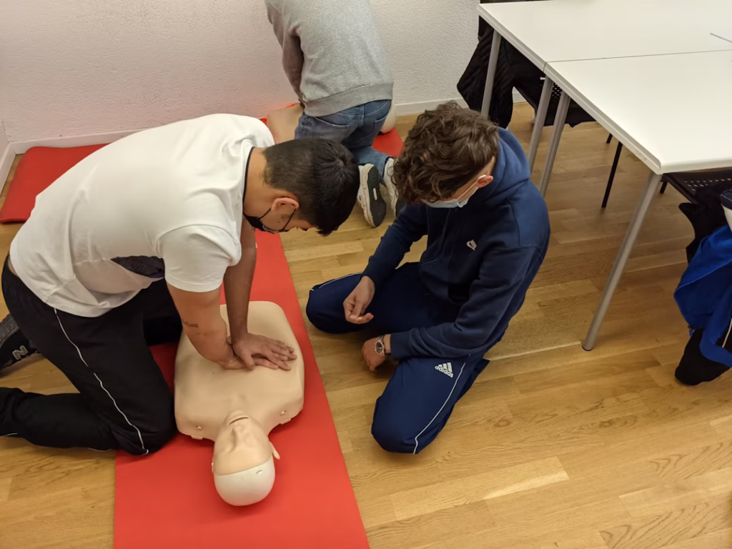 a man giving CPR on a practising doll