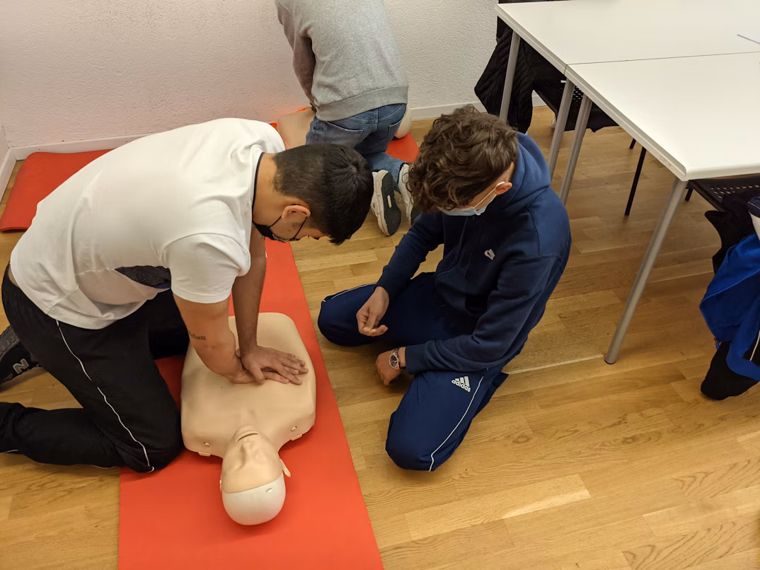 a man giving CPR on a practising doll