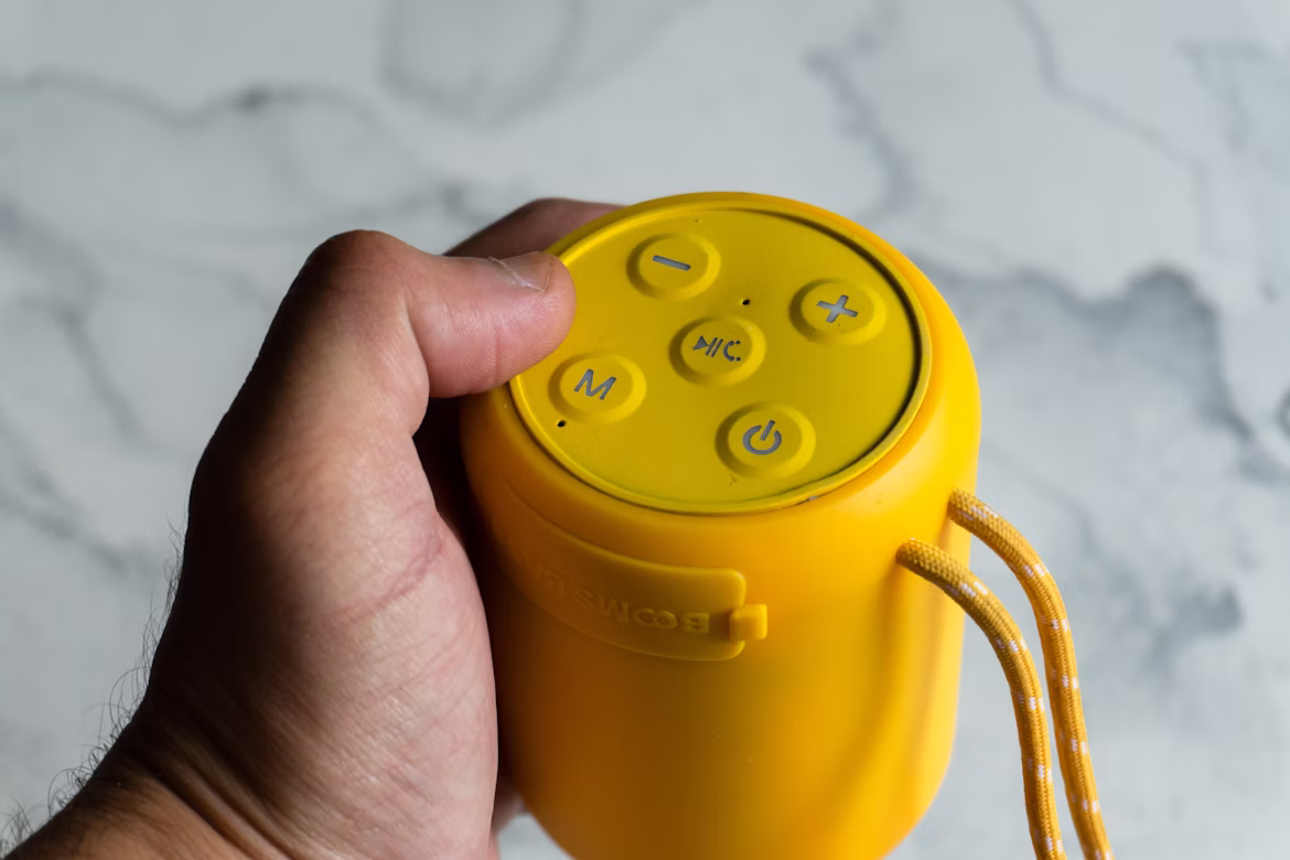 a perso holding speaker in his hand